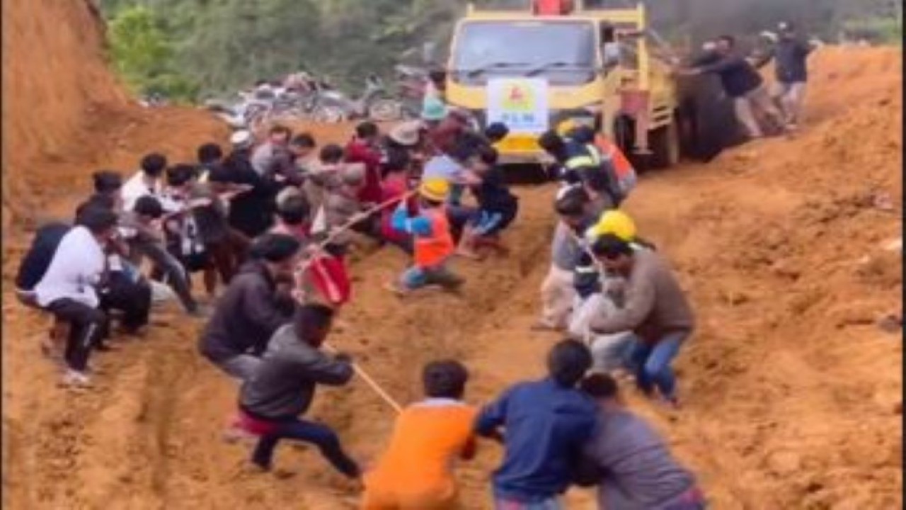 Momen gotong royong petugas dan warga Aceh Tengah tarik truk pembawa material listrik.